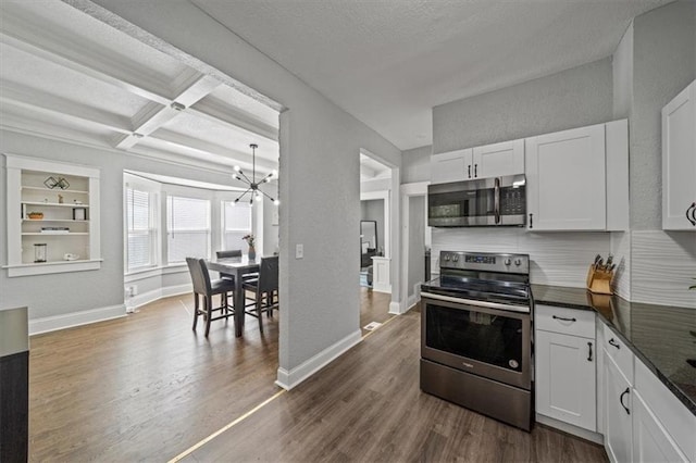 1316 E 42nd St, Kansas City, MO 64110 - kitchen featuring appliances with stainless steel finishes, a chandelier, dark wood-style floors, white cabinetry, and beam ceiling
