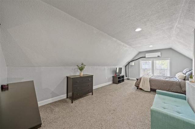 1316 E 42nd St, Kansas City, MO 64110 - bedroom with a textured ceiling, an AC wall unit, vaulted ceiling, baseboards, and carpet flooring