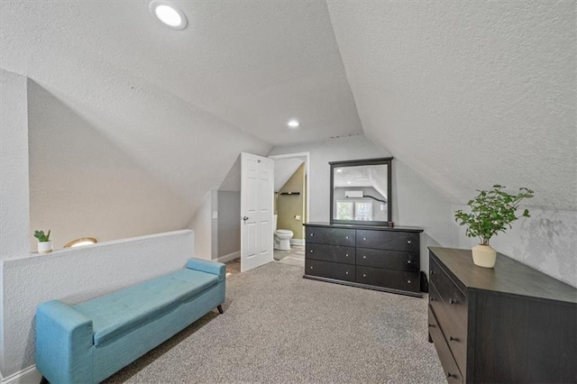 1316 E 42nd St, Kansas City, MO 64110 - living area featuring a textured ceiling, carpet, lofted ceiling, and baseboards