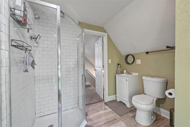 1316 E 42nd St, Kansas City, MO 64110 - full bathroom featuring wood finished floors, toilet, a shower stall, lofted ceiling, and baseboards