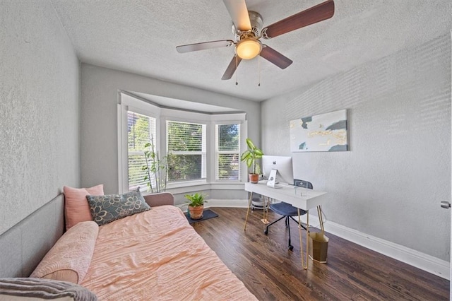 1316 E 42nd St, Kansas City, MO 64110 - home office with a textured wall, wood finished floors, baseboards, a textured ceiling, and ceiling fan