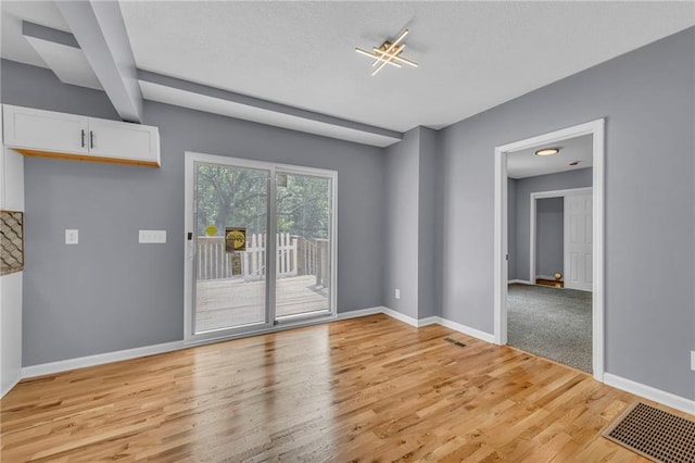 2311 Shawnee Dr, Kansas City, KS 66106 - spare room with light wood-type flooring, baseboards, and a textured ceiling
