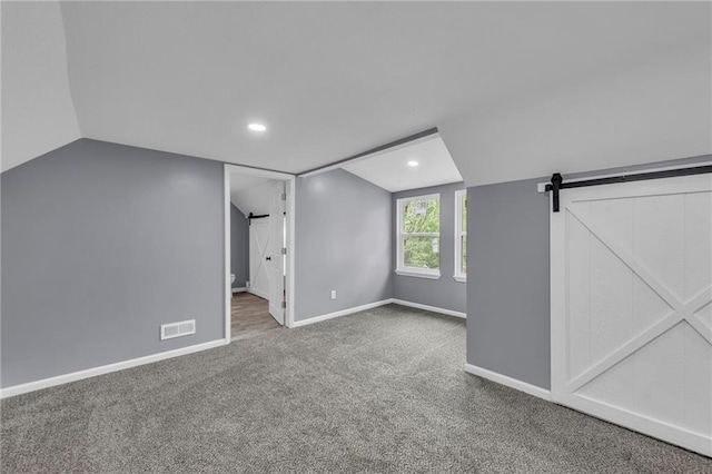 2311 Shawnee Dr, Kansas City, KS 66106 - additional living space featuring carpet floors, lofted ceiling, a barn door, baseboards, and recessed lighting