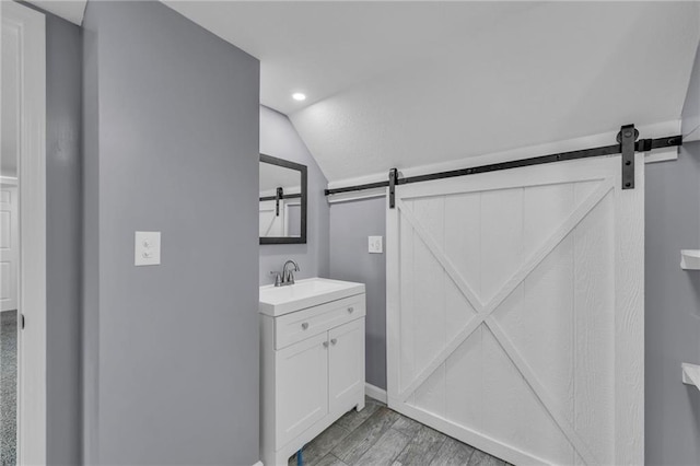 2311 Shawnee Dr, Kansas City, KS 66106 - bathroom featuring vaulted ceiling, vanity, recessed lighting, baseboards, and wood finished floors