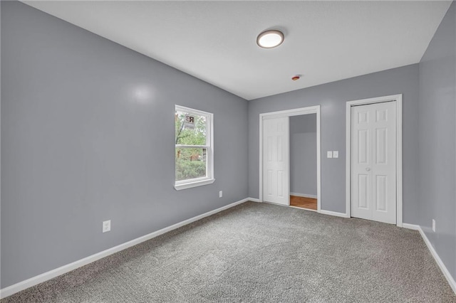 2311 Shawnee Dr, Kansas City, KS 66106 - unfurnished bedroom with carpet flooring, two closets, and baseboards