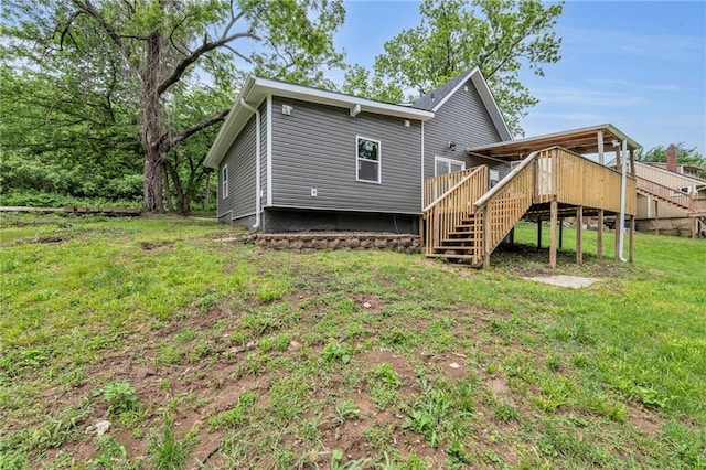 2311 Shawnee Dr, Kansas City, KS 66106 - back of property with stairs, a deck, and a yard