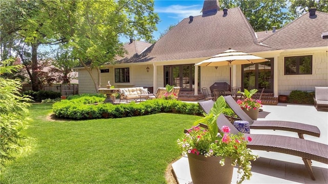 2210 W 69th Ter, Mission Hills, KS 66208 - back of property featuring french doors, a patio area, a shingled roof, and outdoor lounge area