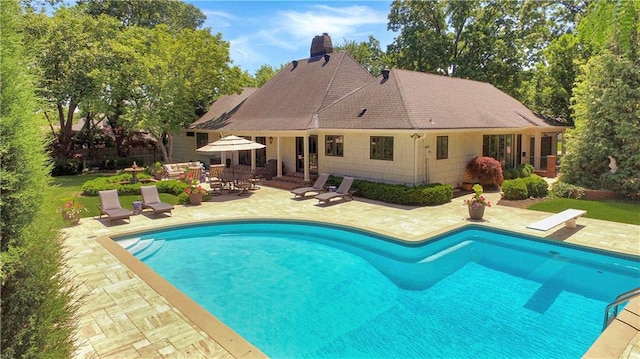 2210 W 69th Ter, Mission Hills, KS 66208 - outdoor pool with a patio and a diving board