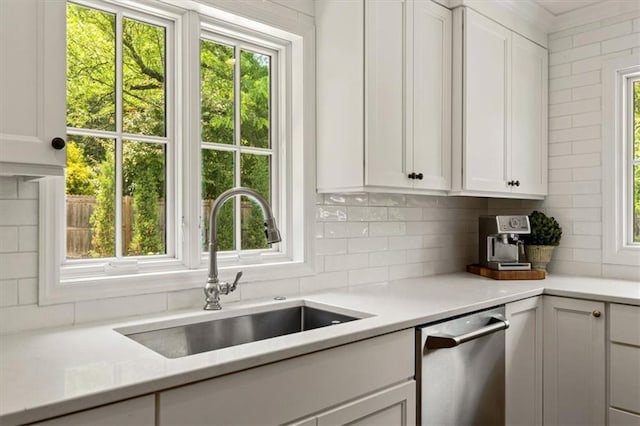 2210 W 69th Ter, Mission Hills, KS 66208 - kitchen with a sink, stainless steel dishwasher, backsplash, and light countertops