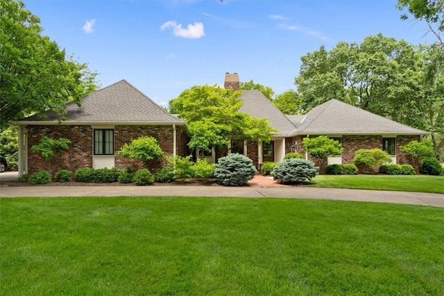 2210 W 69th Ter, Mission Hills, KS 66208 - view of front facade featuring a chimney, a front lawn, and brick siding