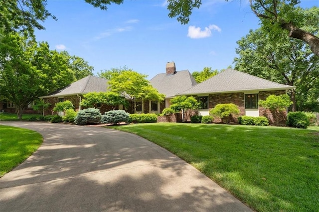 2210 W 69th Ter, Mission Hills, KS 66208 - view of front of property with a front lawn, brick siding, and a chimney