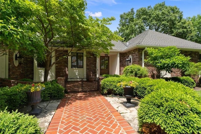 2210 W 69th Ter, Mission Hills, KS 66208 - view of front of home featuring a gate, brick siding, and a shingled roof