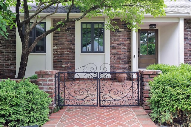 2210 W 69th Ter, Mission Hills, KS 66208 - doorway to property with brick siding, stucco siding, and roof with shingles