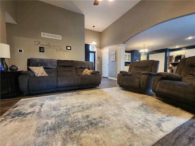 9001 NE 109th Ter, Kansas City, MO 64157 - living area with dark wood-style floors, a ceiling fan, decorative columns, arched walkways, and high vaulted ceiling