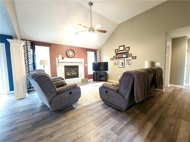9001 NE 109th Ter, Kansas City, MO 64157 - living area featuring a ceiling fan, wood finished floors, lofted ceiling, plenty of natural light, and a fireplace