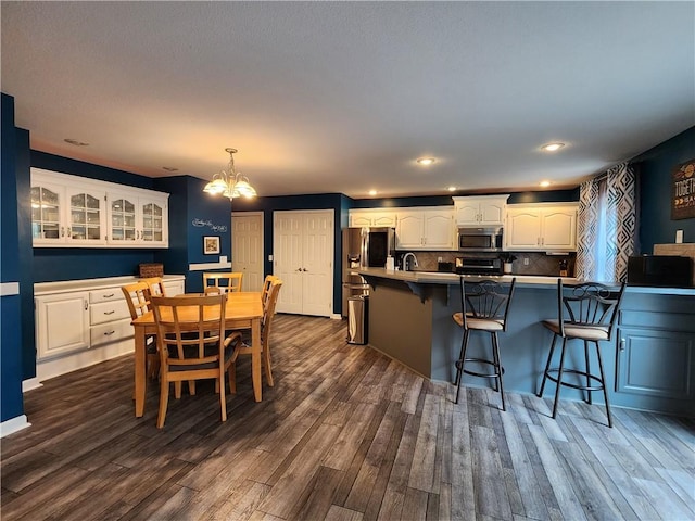 9001 NE 109th Ter, Kansas City, MO 64157 - dining room featuring a chandelier, dark wood finished floors, and recessed lighting