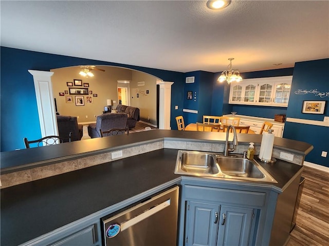 9001 NE 109th Ter, Kansas City, MO 64157 - bar area featuring decorative columns, dishwasher, arched walkways, a sink, and dark wood-style floors