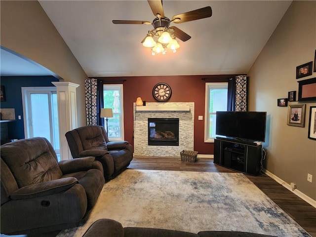 9001 NE 109th Ter, Kansas City, MO 64157 - living room with vaulted ceiling, wood finished floors, plenty of natural light, a stone fireplace, and baseboards