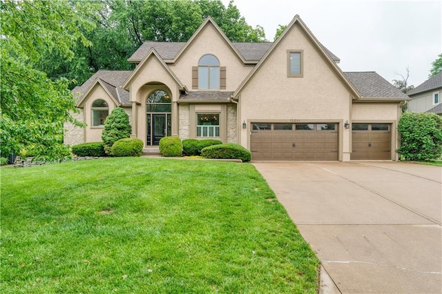 13011 Long St, Overland Park, KS 66213 - traditional home with stucco siding, driveway, a front lawn, and a shingled roof