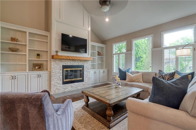 13011 Long St, Overland Park, KS 66213 - living room featuring a stone fireplace, wood finished floors, ceiling fan, lofted ceiling, and built in features