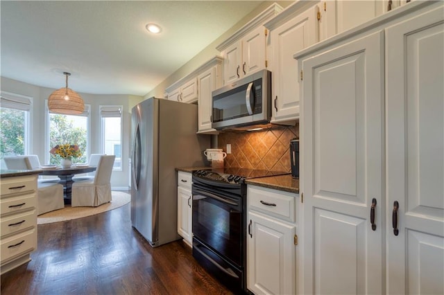 13011 Long St, Overland Park, KS 66213 - kitchen with appliances with stainless steel finishes, tasteful backsplash, dark wood-style flooring, recessed lighting, and white cabinets