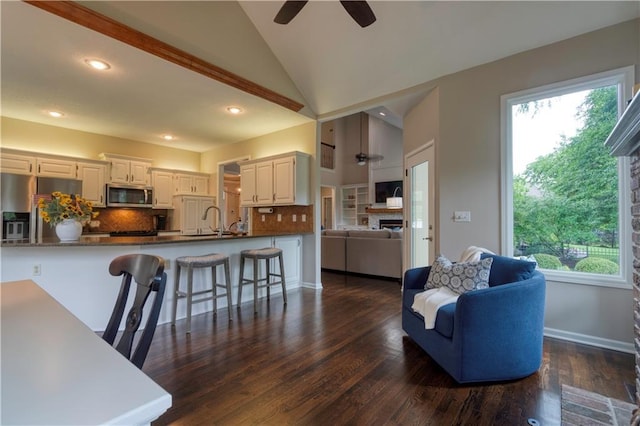 13011 Long St, Overland Park, KS 66213 - living room with a ceiling fan, vaulted ceiling, recessed lighting, dark wood finished floors, and baseboards