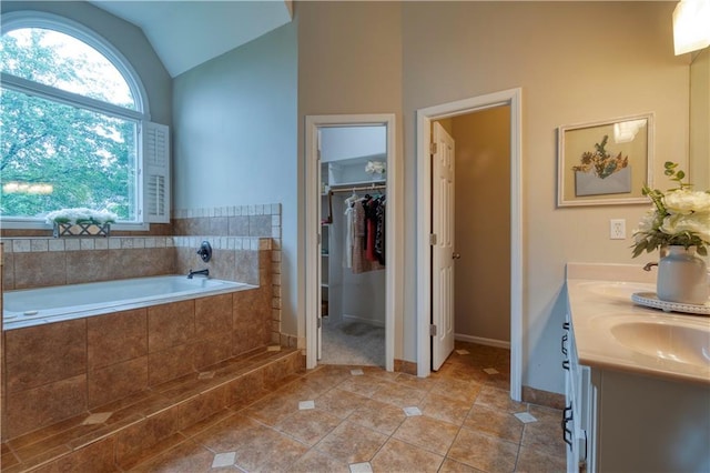 13011 Long St, Overland Park, KS 66213 - full bath with tile patterned floors, lofted ceiling, double vanity, a garden tub, and a spacious closet