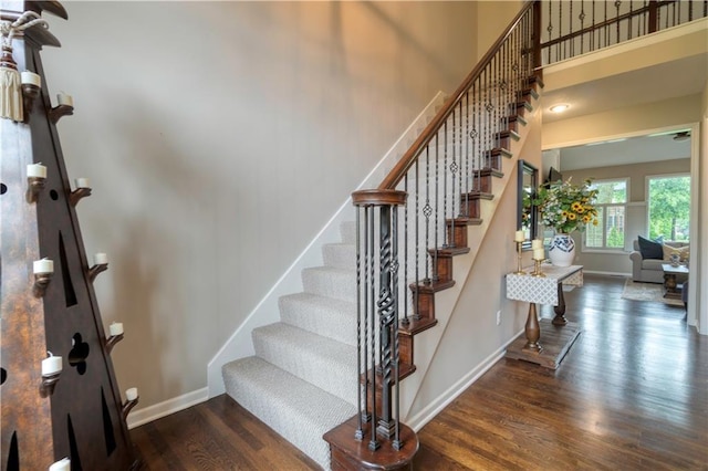 13011 Long St, Overland Park, KS 66213 - stairway featuring wood finished floors, baseboards, and a towering ceiling