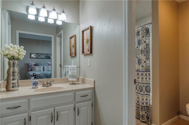 13011 Long St, Overland Park, KS 66213 - ensuite bathroom featuring vanity, toilet, tile patterned flooring, and curtained shower