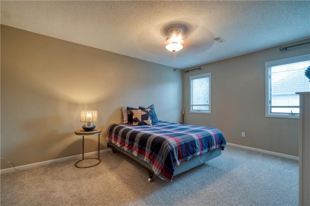 13011 Long St, Overland Park, KS 66213 - bedroom with carpet, a textured ceiling, baseboards, and a ceiling fan