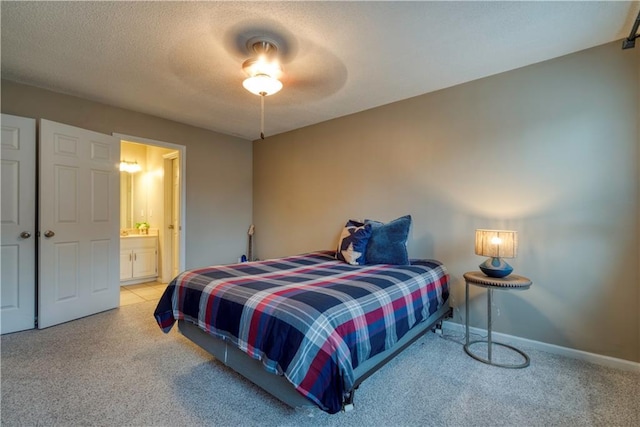 13011 Long St, Overland Park, KS 66213 - bedroom with light carpet, ensuite bathroom, baseboards, and a ceiling fan
