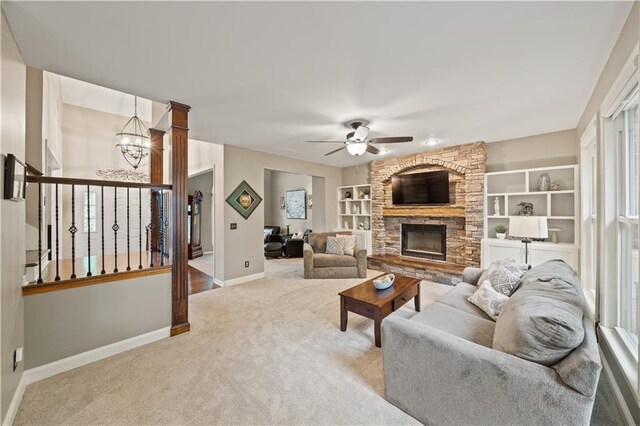 14450 W 146th Ter, Olathe, KS 66062 - living area featuring carpet flooring, baseboards, ceiling fan, a fireplace, and a chandelier