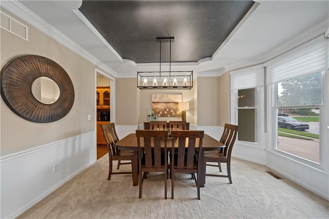 14450 W 146th Ter, Olathe, KS 66062 - dining room featuring a raised ceiling, light colored carpet, a chandelier, ornamental molding, and baseboards