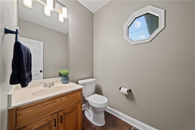 14450 W 146th Ter, Olathe, KS 66062 - bathroom with toilet, vanity, baseboards, and wood finished floors