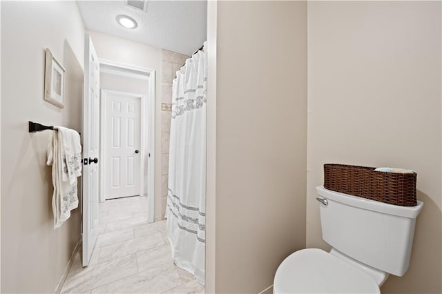 14450 W 146th Ter, Olathe, KS 66062 - bathroom featuring baseboards, toilet, curtained shower, and marble finish flooring
