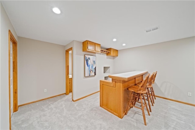 14450 W 146th Ter, Olathe, KS 66062 - kitchen with light carpet, baseboards, a breakfast bar area, recessed lighting, and a peninsula