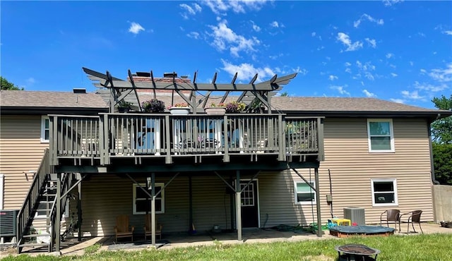1211 N 6th St, Hiawatha, KS 66434 - rear view of house featuring an outdoor fire pit, a deck, central air condition unit, stairway, and a patio