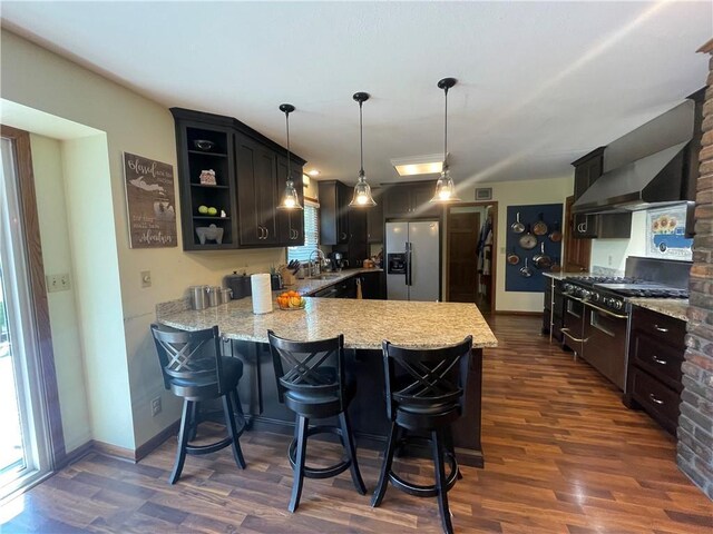 1211 N 6th St, Hiawatha, KS 66434 - kitchen featuring appliances with stainless steel finishes, dark wood-style floors, open shelves, and a peninsula