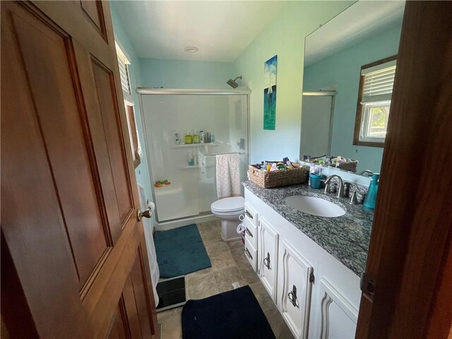 1211 N 6th St, Hiawatha, KS 66434 - full bathroom featuring a shower stall, vanity, and toilet