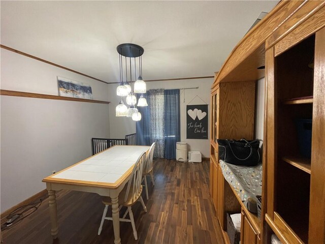 1211 N 6th St, Hiawatha, KS 66434 - dining area featuring dark wood finished floors, crown molding, and a chandelier