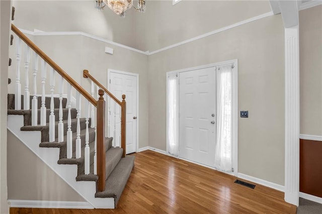 12726 S Rene St, Olathe, KS 66062 - foyer entrance featuring wood finished floors, stairs, baseboards, and a chandelier