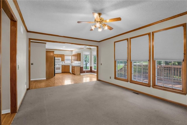 12726 S Rene St, Olathe, KS 66062 - unfurnished living room featuring light colored carpet, a ceiling fan, crown molding, baseboards, and a textured ceiling