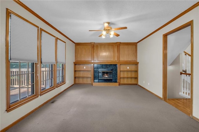 12726 S Rene St, Olathe, KS 66062 - unfurnished living room featuring ornamental molding, carpet flooring, ceiling fan, a fireplace, and baseboards