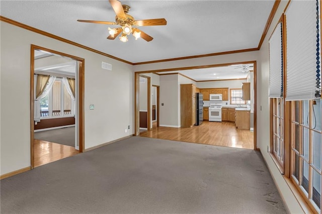 12726 S Rene St, Olathe, KS 66062 - unfurnished living room with light colored carpet, a ceiling fan, crown molding, and baseboards