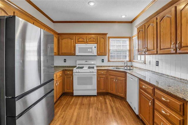 12726 S Rene St, Olathe, KS 66062 - kitchen featuring white appliances, a sink, brown cabinets, crown molding, and light wood-style floors