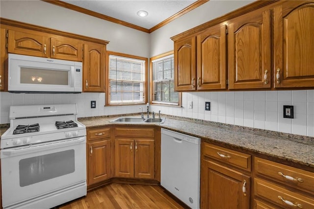 12726 S Rene St, Olathe, KS 66062 - kitchen featuring white appliances, a sink, ornamental molding, light wood-style floors, and brown cabinets
