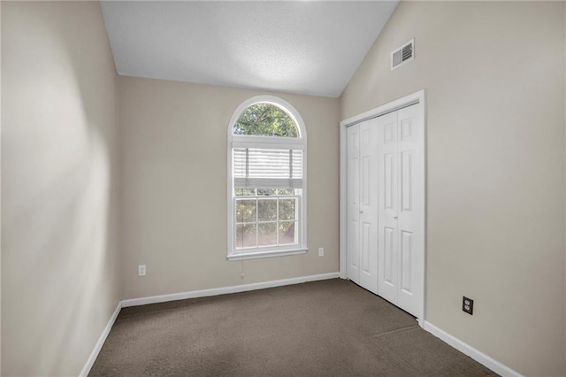 12726 S Rene St, Olathe, KS 66062 - unfurnished bedroom with lofted ceiling, baseboards, dark carpet, and a closet