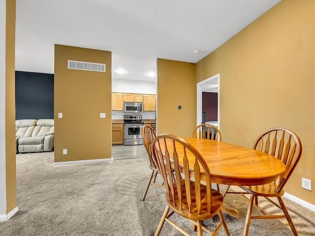 1151 N Mart-Way Dr Unit 103, Olathe, KS 66061 - dining room featuring baseboards, light carpet, and recessed lighting