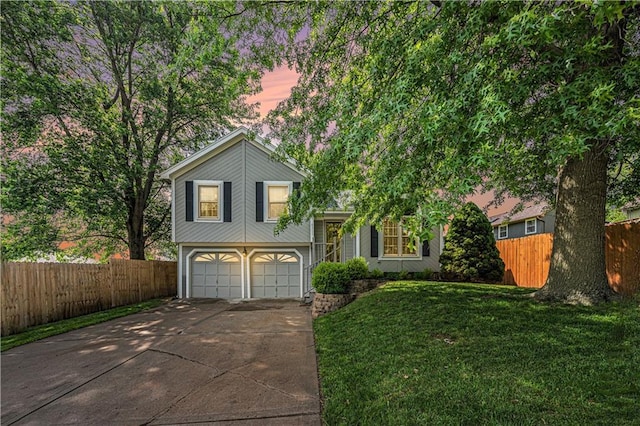 8311 NE 112th St, Kansas City, MO 64157 - split level home featuring concrete driveway and an attached garage