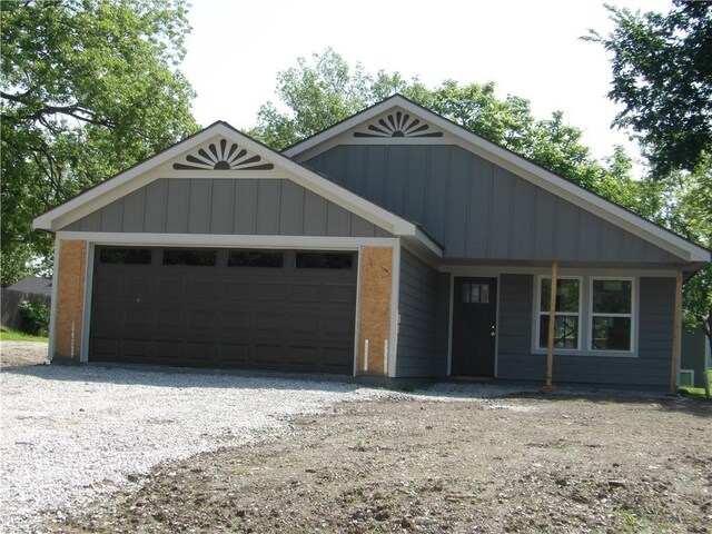 303 S Lexington St, Holden, MO 64061 - ranch-style house featuring a garage and board and batten siding